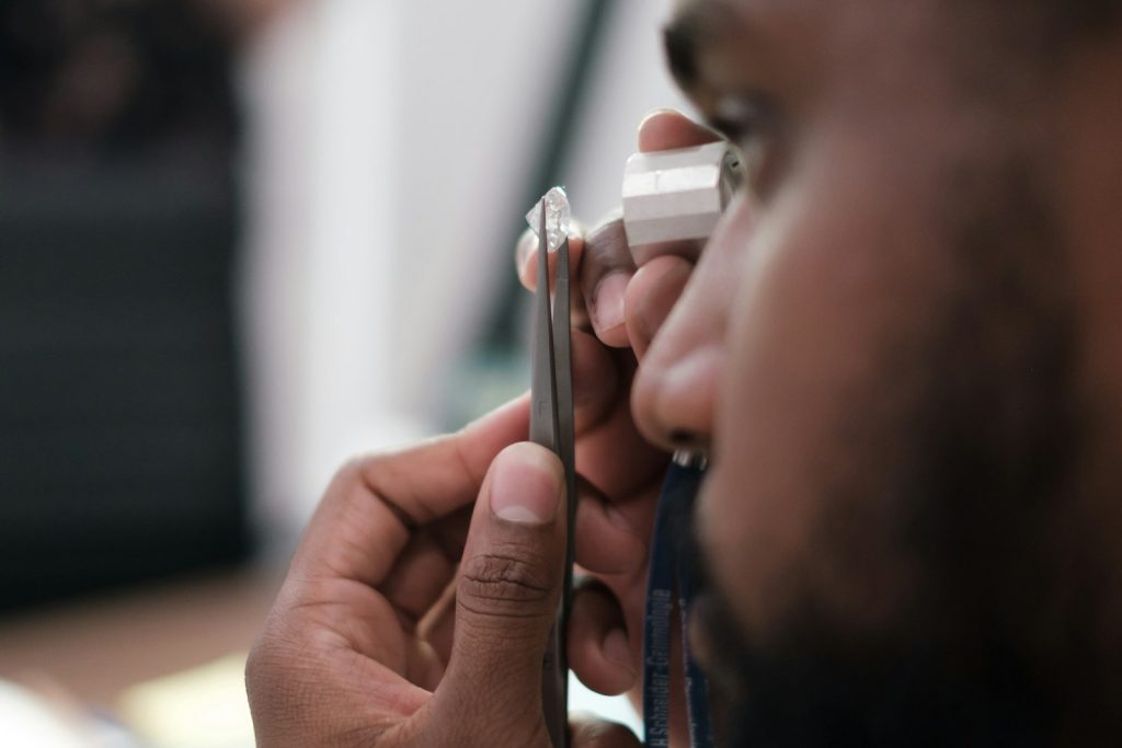 a man using a stethoscope to examine a person's ear