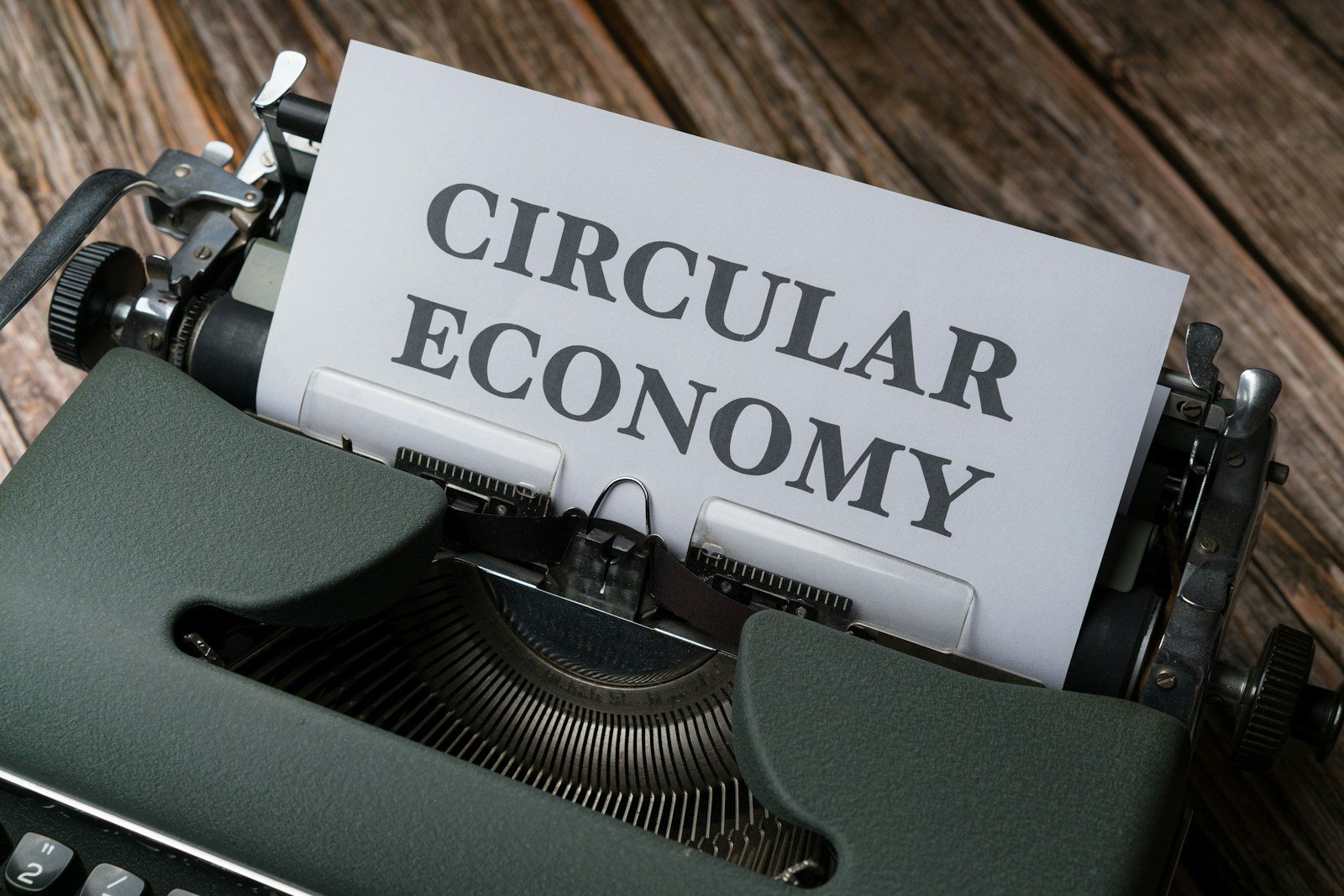 a close up of a typewriter with a paper that reads circular economy